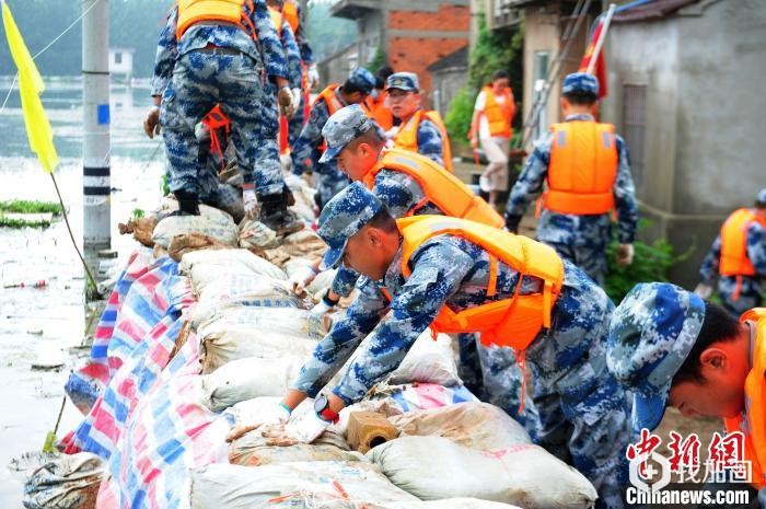 7月14日，中国人民解放军94655部队官兵驰援安徽省芜湖市繁昌县荻港镇庆大圩，开展防汛抢险行动，对堤坝进行进一步加固。　杨大伟 摄