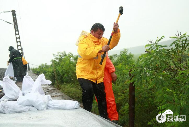 作业人员雨中打桩加固土体